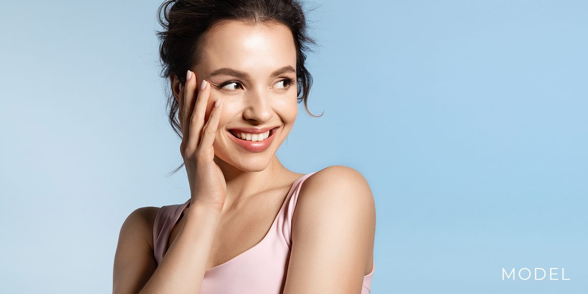 Young Female in Pink Shirt with Smooth Facial Skin